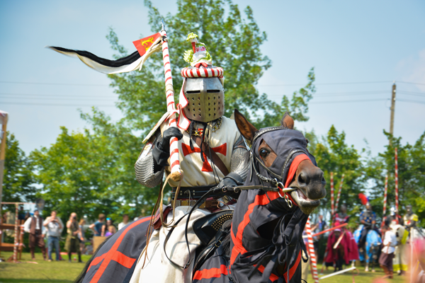 A jousting knight on a horse at a renaissance fair
