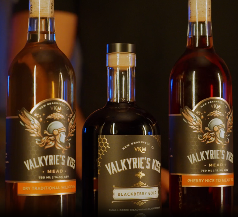 Three bottles of Valkyrie's Kiss Mead. Dry Traditional, Blackberry Gold, and Cherry.